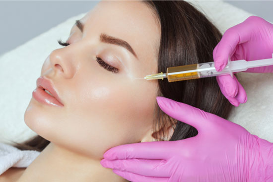 PRP skin rejuvenation treatment performed on a patient's cheek at an aesthetic clinic.